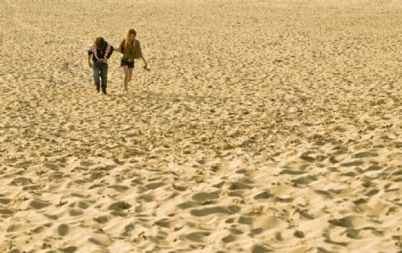 男女双携砂丘漫步图片
