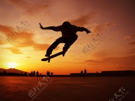 夕阳下玩滑板的帅哥图片
