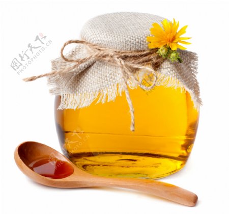 一罐蜂蜜和木勺图片