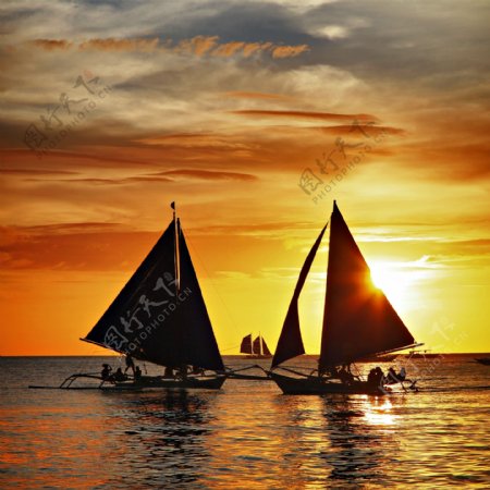 落日海面的帆船图片